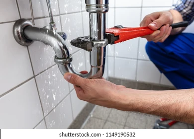 male-plumbers-hand-repairing-sink